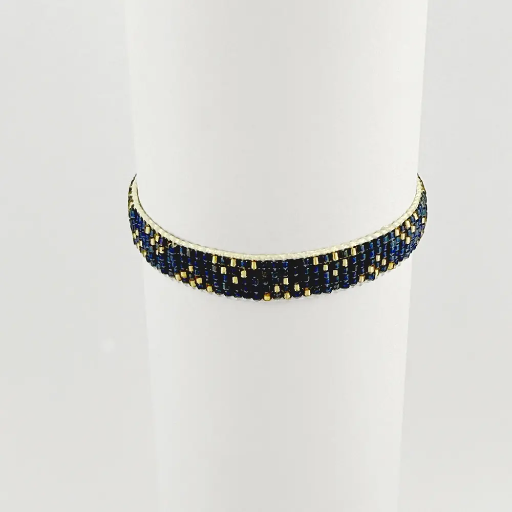 Pulsera artesanal tejida en miyuki cordón ajustable tonos azules y dorados