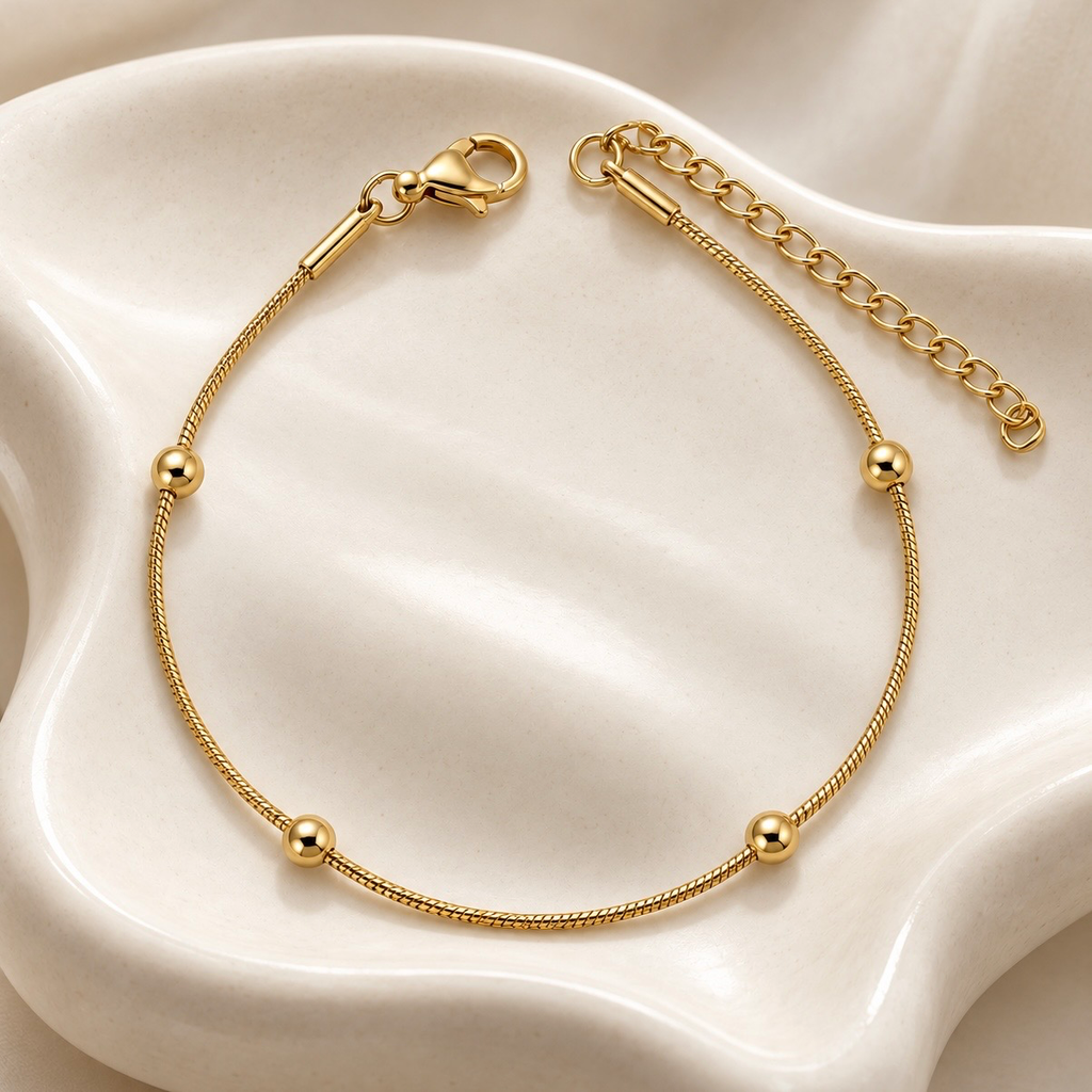 Pulsera en acero inoxidable dorada bolitas