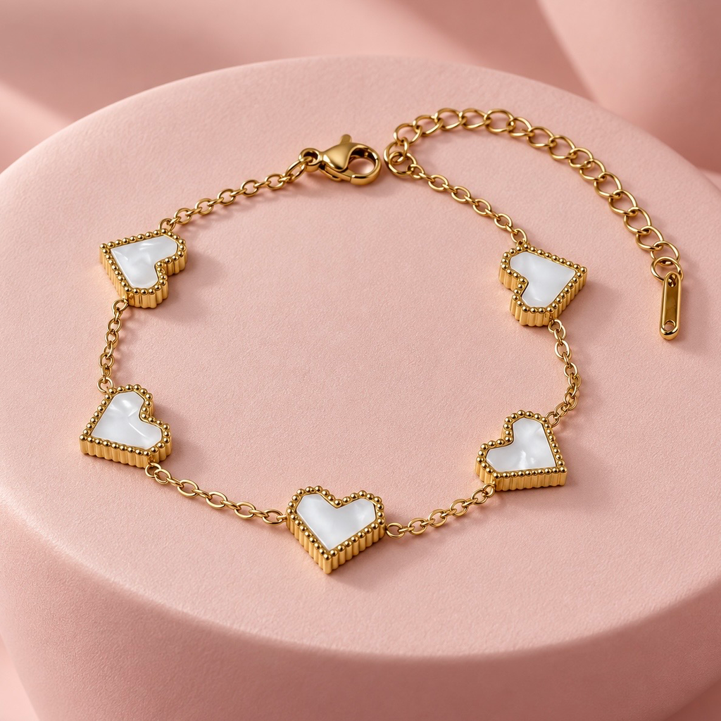 Pulsera en acero inoxidable dorada corazones carey blanco